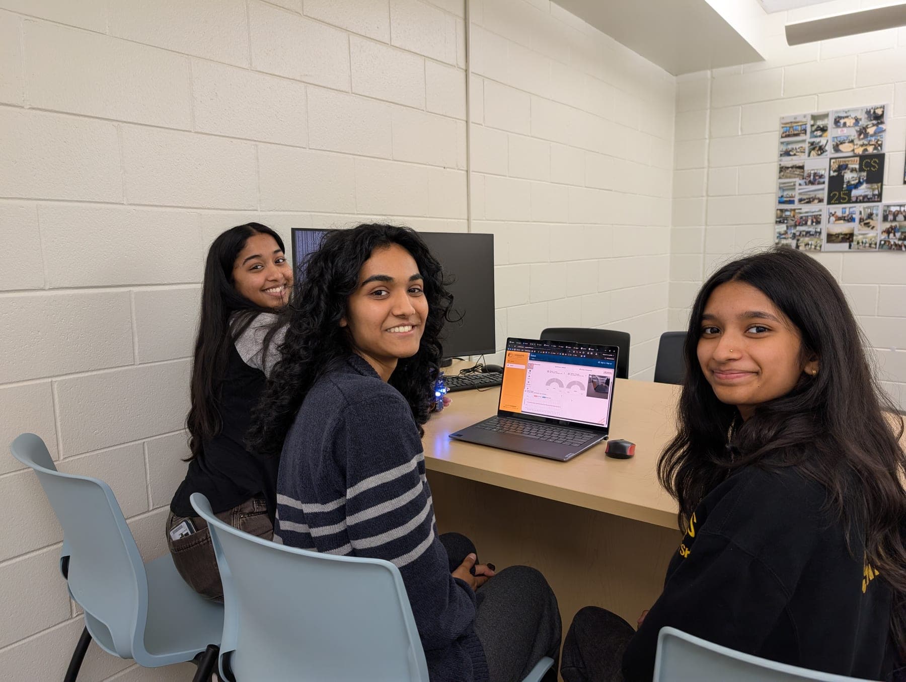 Students reviewing DuckieBot telemetry at a lab workstation